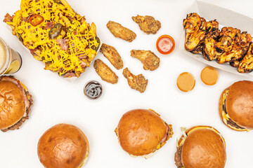 The classic, hearty presentation of a family-style burger, where cheese covers the entire patty and fries are piled high on one side of the plate.