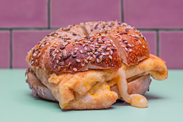 A bagel, split in half, reveals a perfect layer of cream cheese, artfully arranged slivers of smoked salmon, golden capers, and a delicate drizzle of olive oil.