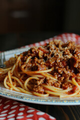 Fototapeta premium A close-up shot of delicious spaghetti Bolognese with rich meat sauce and grated cheese, perfect for Italian cuisine lovers.