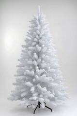 Elegant tall artificial Christmas tree with pristine white branches and delicate snow accents