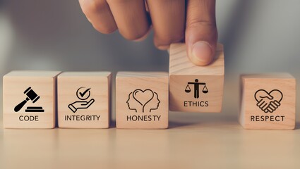 Code of conduct in business concept. Wooden blocks with code of conduct icons; code, integrity, honesty, respect, and ethics, the foundation of a strong corporate code of conduct. Corporate ethics.