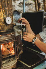 Woman's hand pouring tea from samovar
