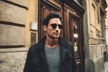 Obraz premium Portrait of stylish man in casual outfit, daylight warm tones.
