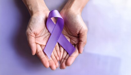 hand holding purple awareness ribbon pancreatic cancer alzheimer disease epilepsy