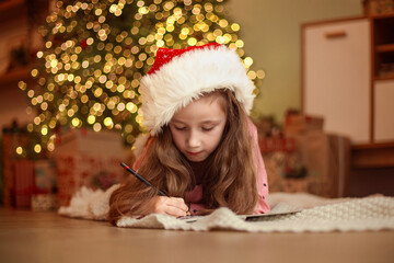 Christmas wish list, Girl writing letter to Santa Claus, christmas, holidays and childhood concept, girl making wish list or letter to santa at home