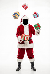 A full-body shot of Santa in his suit, with his face completely blacked out, juggling and holding several colorful gift boxes against a bright white background.