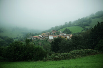 Mountain village in a green hillside landscape. Pedroveya village in Asturias