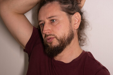 Obraz premium Man thinking with arm raised contemplating serious problem