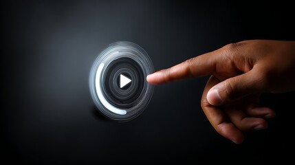 Close-up of dark hand touching glowing play button over black background