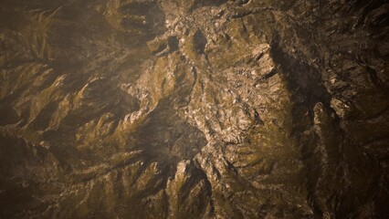 The rugged terrain showcases an array of peaks and valleys, illuminated by the warm glow of the setting sun. Shadows dance across the surface, creating a captivating display of natures artistry.