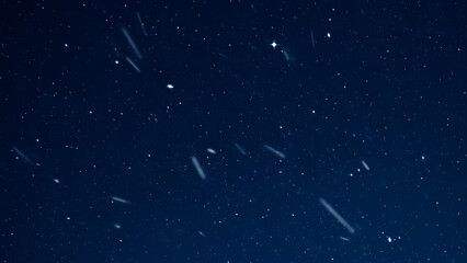 Night sky with stars and meteors during meteor shower event