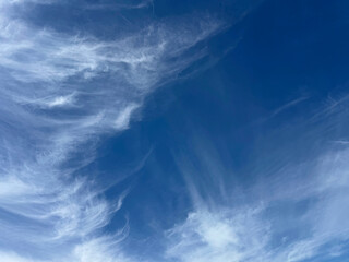Blue sky with gentle wispy clouds.