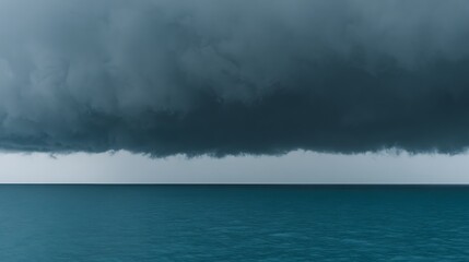 Dramatic seascape captures dark, ominous clouds over a calm ocean, evoking a sense of foreboding
