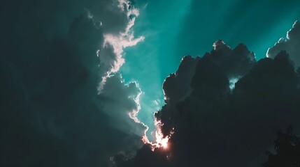 Dramatic sky with radiant sunbeams piercing through dark clouds. Nature's beauty