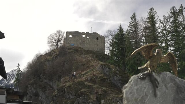 Fussen Germany. Burgruine Falkenstein Allgau bei Pfronten ruined medieval castle in Pfronten in Ostallgau in Sudwest Bayern. Tourists and visitors around the ruins of castle on hill. 