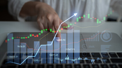A businessperson interacts with stock market data on a laptop, visualizing financial trends and making informed investment decisions for future growth. Scalp