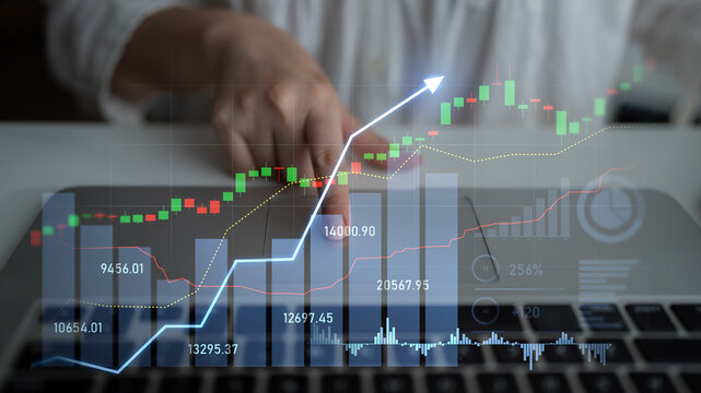 A businessperson interacts with stock market data on a laptop, visualizing financial trends and making informed investment decisions for future growth. Scalp - Powered by Adobe