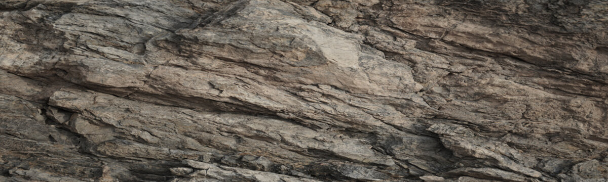 Light brown beige gray granite rock stone background. Mountain surface. Close-up. Cracked crumbled crashed weathered grunge. Nature. For design. Wide banner. Panoramic.