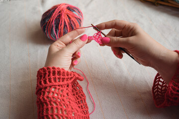 female hands crocheting colorful yarn. multicolor yarn wool textured pattern for crochet