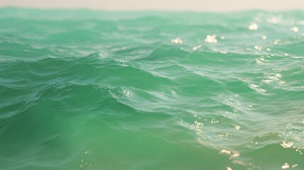 Close-up of turquoise ocean waves shimmering under sunlight. Gentle motion. Serene ambiance