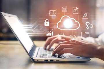 Explore the integration of modern technology with a user working on a laptop, highlighted by cloud computing and data security icons, representing digital innovation. Gantry