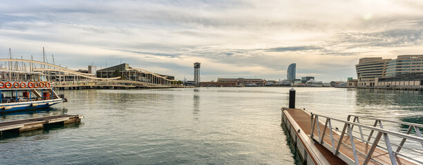 Fototapeta premium Panoramic view of the port of Barcelona with the cable car tower and shopping centre in the marina, Spain.