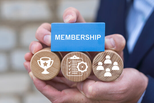Business person holding blocks with icons sees the word MEMBERSHIP. Concept of membership. Business company join us.