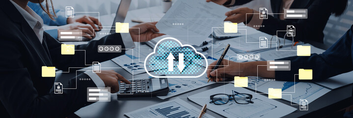 Engaging business team collaborating in a modern workspace, utilizing cloud technology visuals to enhance digital transformation and effective data management strategies. Gantry