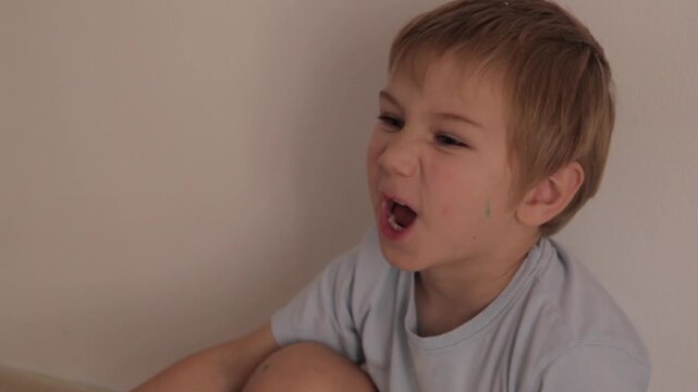 Little boy making funny faces indoors