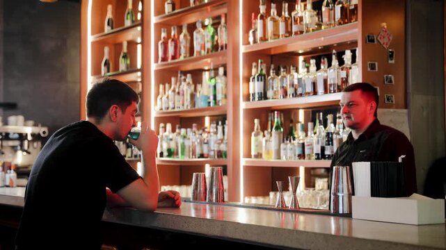 Bartender and customer high fiving at a nightclub bar