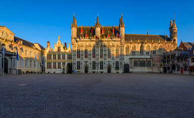 Burg square with Stadhuis van Brugge (The Bruges City Hall) and Basilica of Holly Blood in Bruges, Belgium. Sunrise cityscape of Bruges.