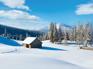 Winter calm mountain landscape with shed and mount ridge behind (Kukol Mount, Carpathian Mountains, Ukraine)