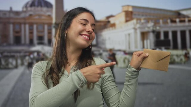 Woman standing in st. peter's square at the vatican, smiling while holding an envelope, showcasing a vibrant and joyful outdoor experience in italy.