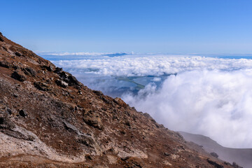 Majestic view from a mountain peak overlooking clouds in Russia