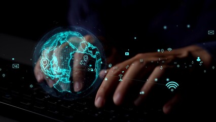 A close-up view of hands typing on a keyboard illuminated by a glowing digital globe surrounded by technology icons, symbolizing global connectivity and digital communication. Xenic