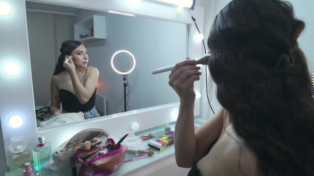 Girl examining makeup in mirror with vanity table visible below