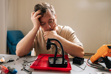 Pensive technician person performing computer cooling system maintenance, disassembling liquid cooler components for cleaning and repair, focusing on hardware upgrade and technology service.