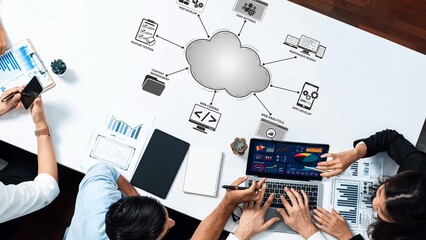 A diverse team collaborates on data analysis in a modern office, showcasing cloud computing tools, devices, charts, and infographics to enhance productivity and innovation. Raster