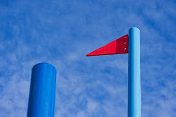 Metal pole with fixed red triangular signal flag marker