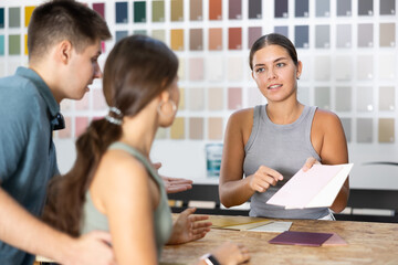 Seller of hardware store advises married couple of buyer what ceramic tiles to buy