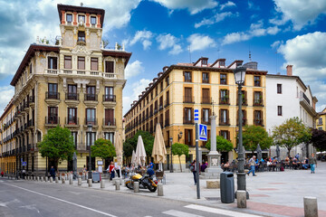 Naklejka premium Old street with table of restaurant in Madrid, Spain. Architecture and landmark of Madrid. Сityscape of Madrid.