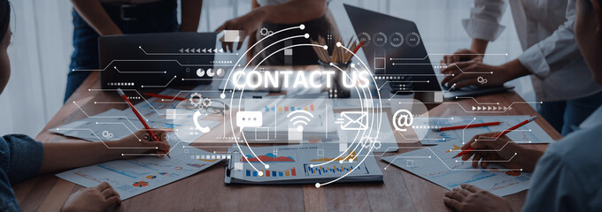 A modern office meeting scene featuring professionals engaged in discussion and planning with digital contact icons overlay. Highlighting business communication strategies. Trope