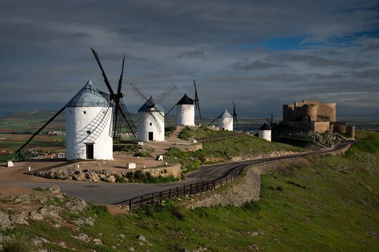 Group of windmills above the Consuegra town, with the fortress in the background.