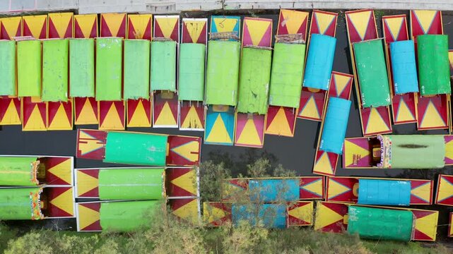 Drone footage of traditional trajineras floating through the historic canals of Xochimilco, Mexico City.
