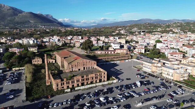 Aerial view of Scauri beach with abandoned old factory construction along the coast