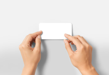 Hands sticking white rectangle sticker, grey background, ai generated