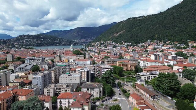 aerial drone view of historic palaces in Como city center with the blue waters of Lake Como in the background 2