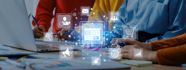 A dynamic office scene featuring a team collaborating on digital marketing strategies, with engaging visuals illustrating various marketing concepts on the laptop. Trope