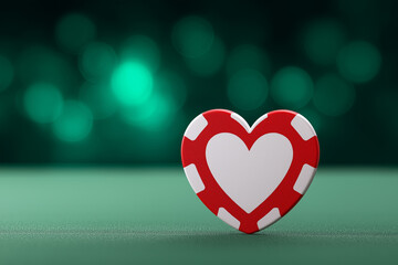Heart-shaped poker chip on green felt with bokeh background