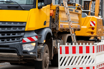 Sity street renovation rebuilding construction site with dump truck flasher excavator digging earth...